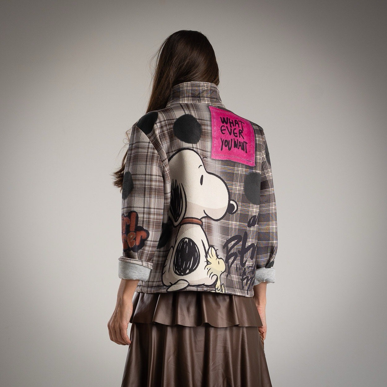 Back view of MARIΓIOÚ plaid jacket featuring large Snoopy print and “Whatever You Want” patch.