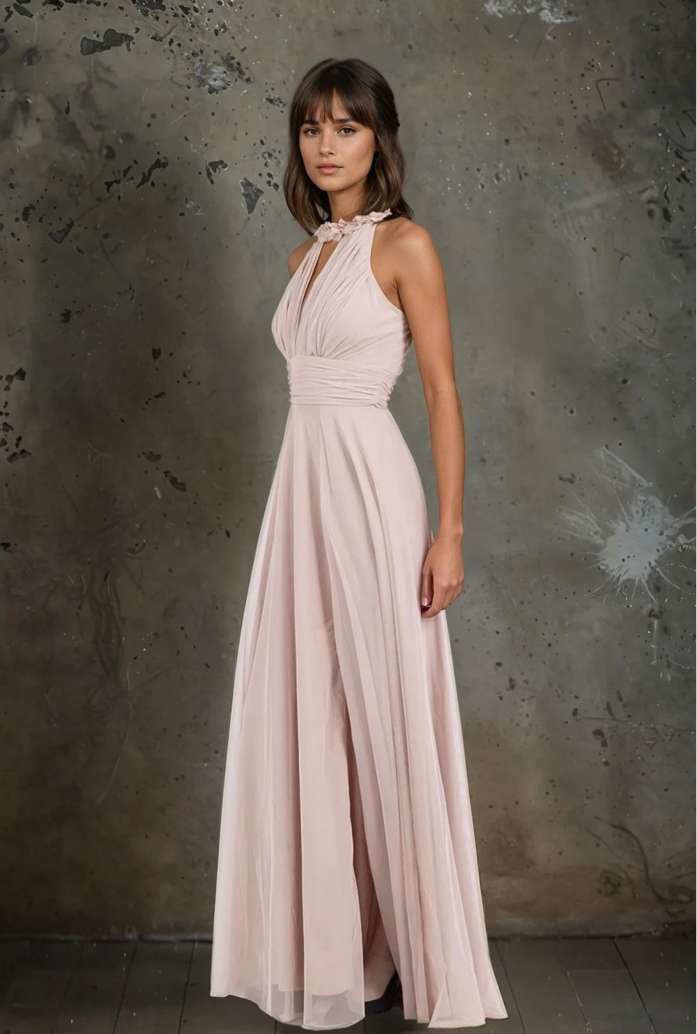 Side profile of flowing blush pink maxi dress with gathered waist and floral neckline – graceful event look by MARIGIOÚ