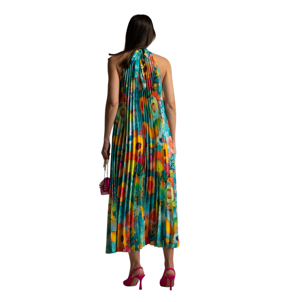 Back view of turquoise pleated dress with halter tie neck and flared silhouette.