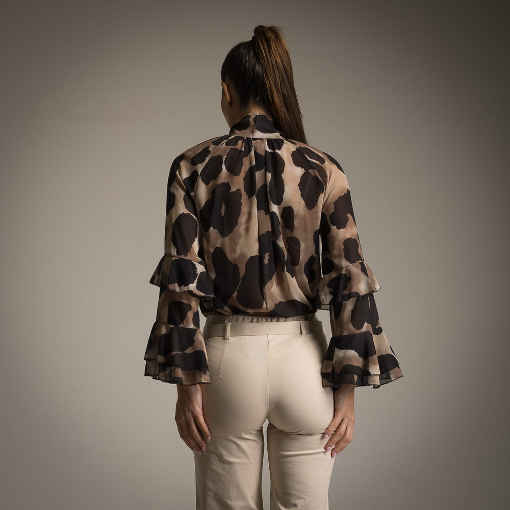 Back view of black watercolour print blouse with layered ruffle sleeves