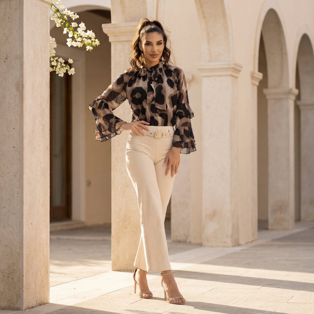 Black watercolour print blouse with ruffle sleeves and bow neckline styled with beige trousers