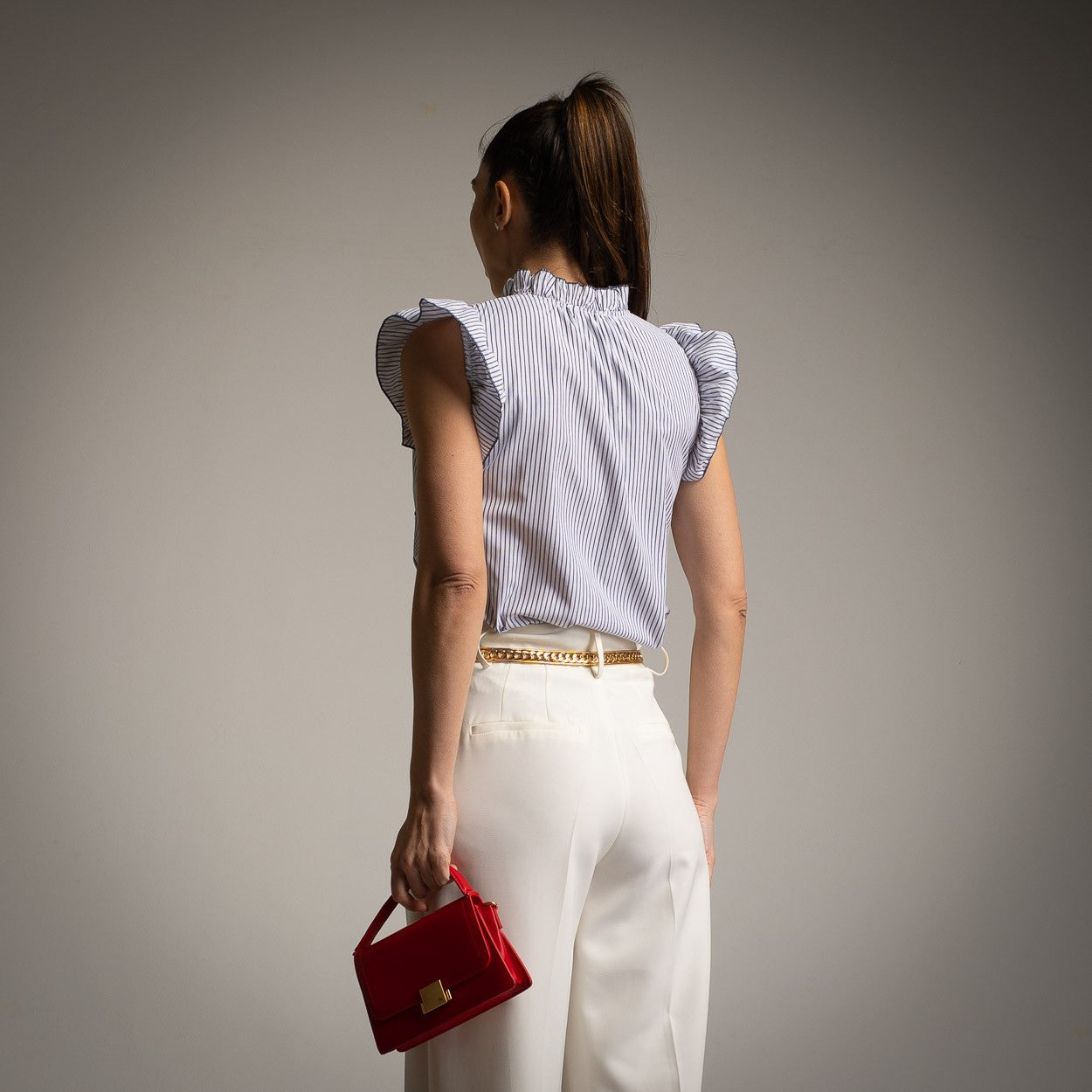 Back view of blue and white striped blouse with short ruffle sleeves