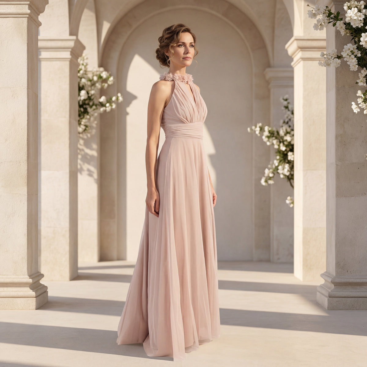 Elegant blush wedding guest dress with flowing maxi silhouette