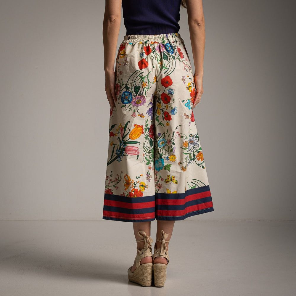 Back view of floral cotton culotte pants in Ivory White with an elastic waistband and colorful floral design.