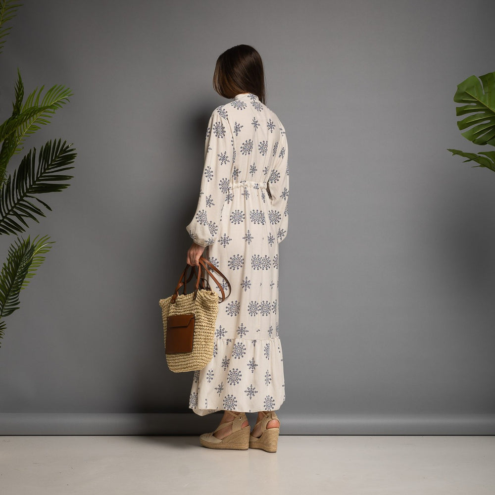 Cream printed maxi dress back view with flowing silhouette