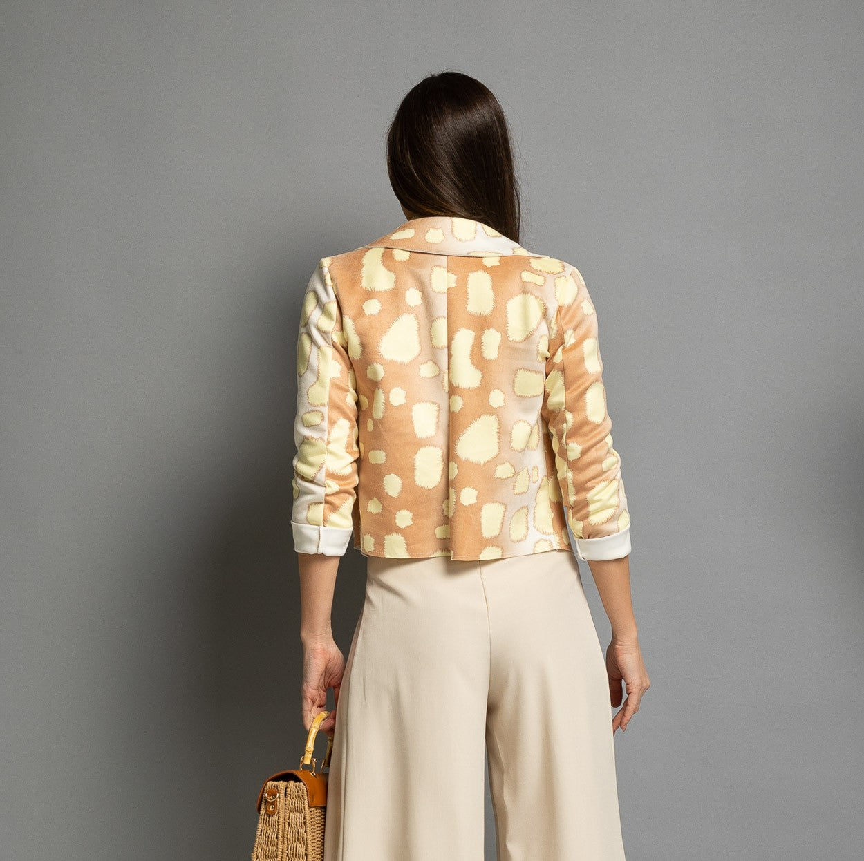 Back view of cropped suede jacket with giraffe print