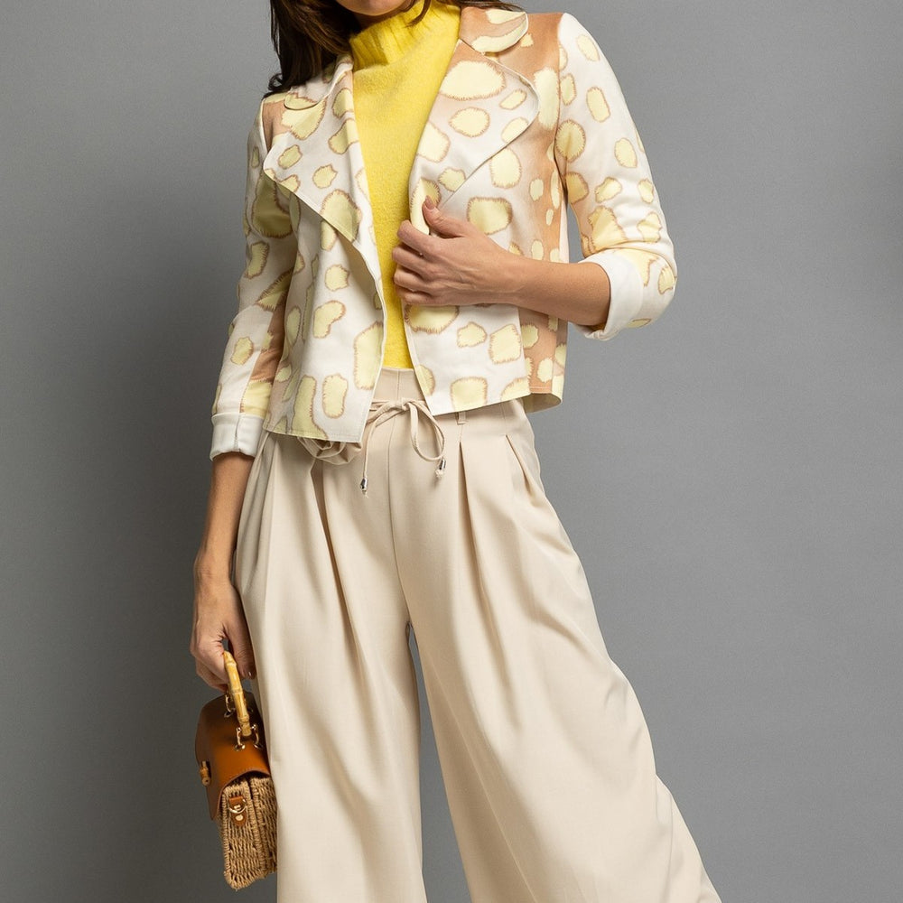 Cropped suede jacket with modern giraffe print styled with beige trousers