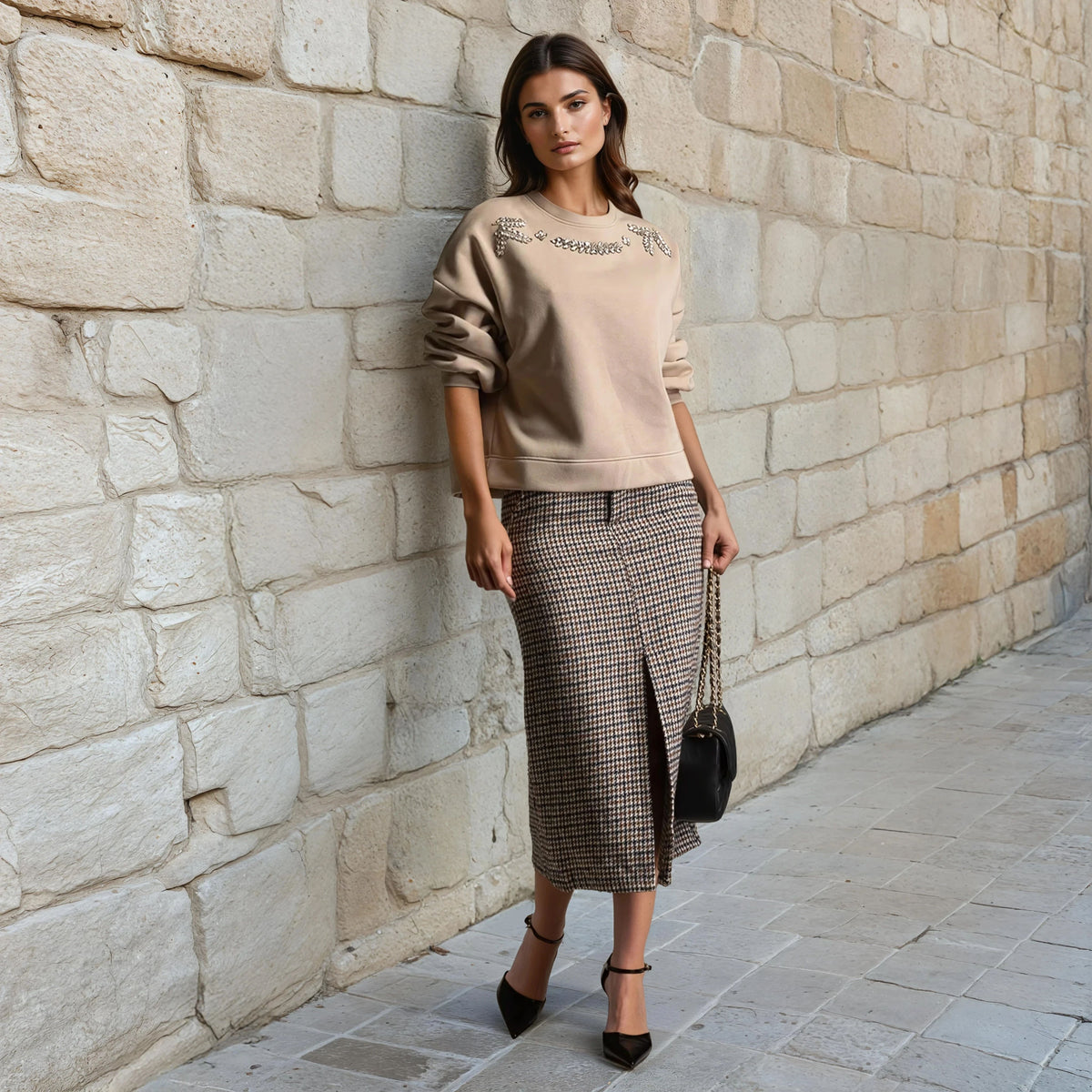 Embellished beige sweatshirt with large rhinestones styled with midi skirt – front view