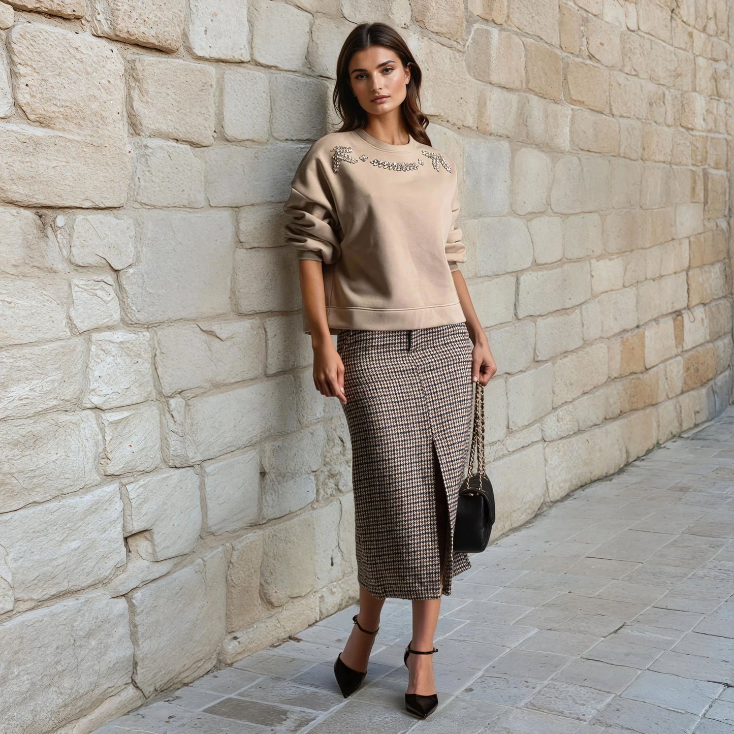 Embellished beige sweatshirt with large rhinestones styled with midi skirt – front view