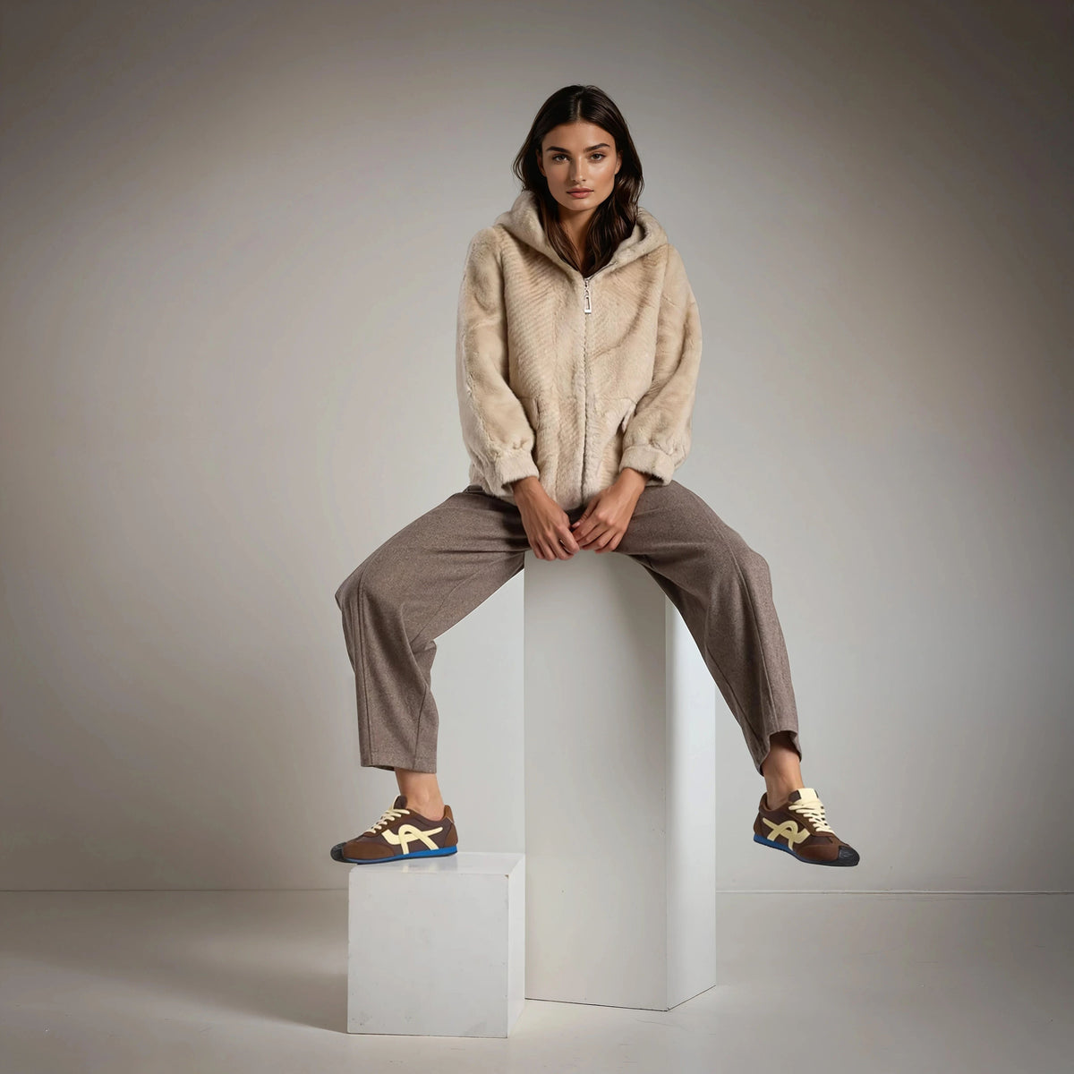 Front view of MARIΓIOÚ faux fur hooded jacket in beige, featuring zip closure and soft plush texture.