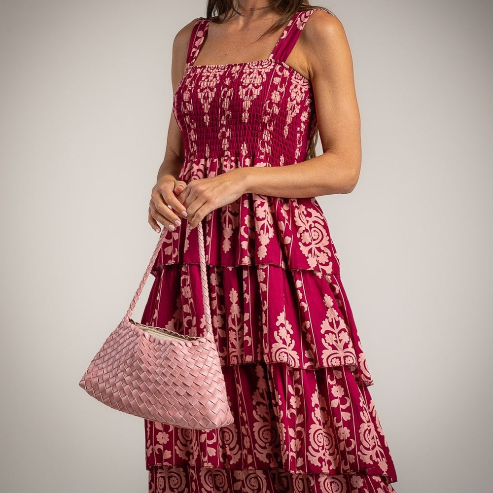 Close up of floral tiered midi dress with smocked bodice and layered ruffles in bougainvillea pink