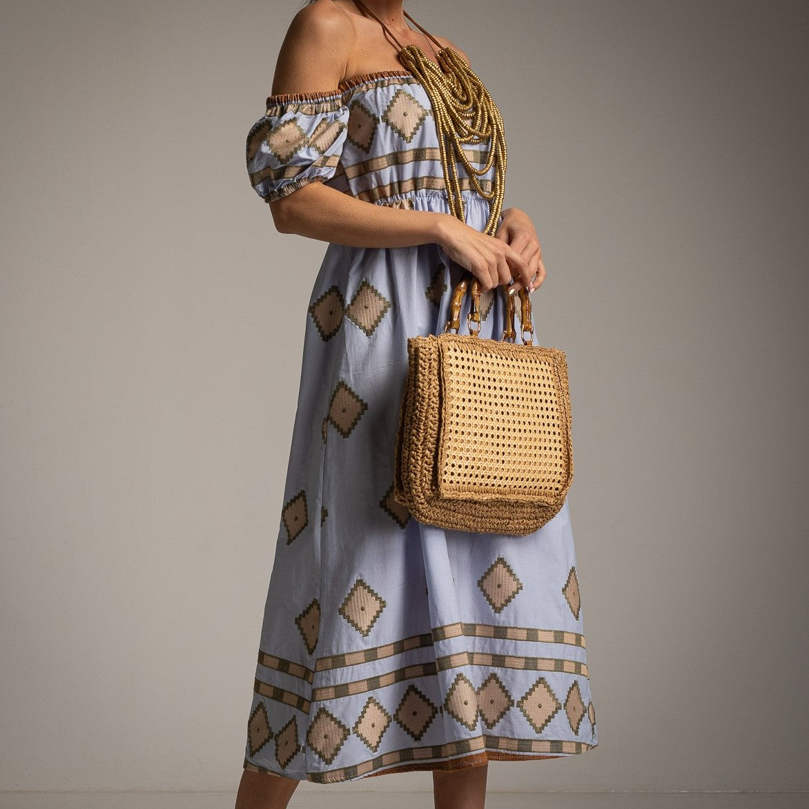 Close-up of MARIΓIOÚ off-shoulder summer dress in Aegean Blue with Mediterranean-inspired pattern
