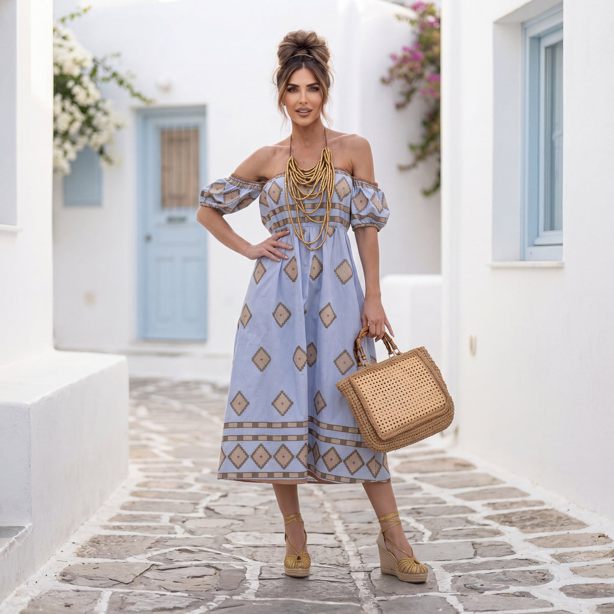 Woman wearing MARIΓIOÚ off-shoulder summer dress in Aegean Blue styled in a Mediterranean resort setting