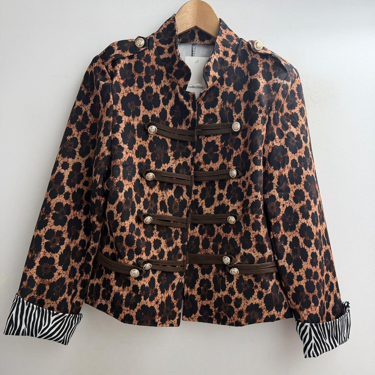 Leopard print military jacket with gold-tone buttons and braided front trims - front view