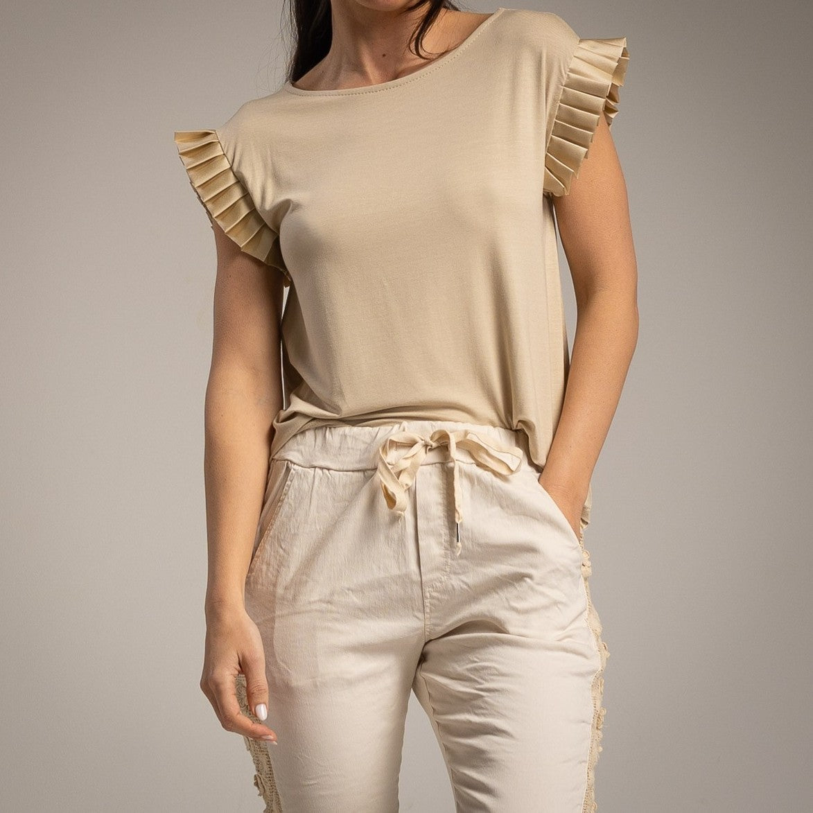 Front detail of the Amalfi Ruffle Sleeve Top in Soft Vanilla Cream featuring elegant layered ruffle sleeves.