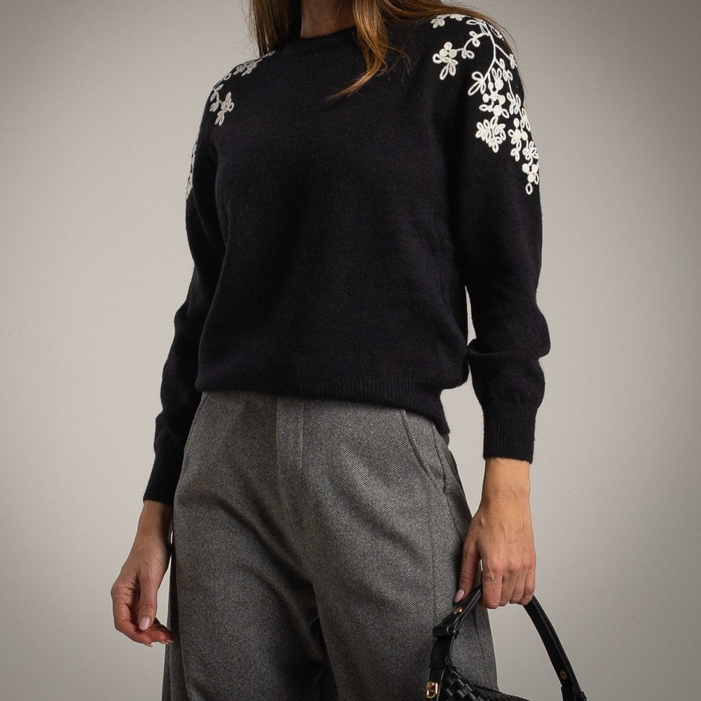 Black knit sweater with ivory floral shoulder embroidery - front view