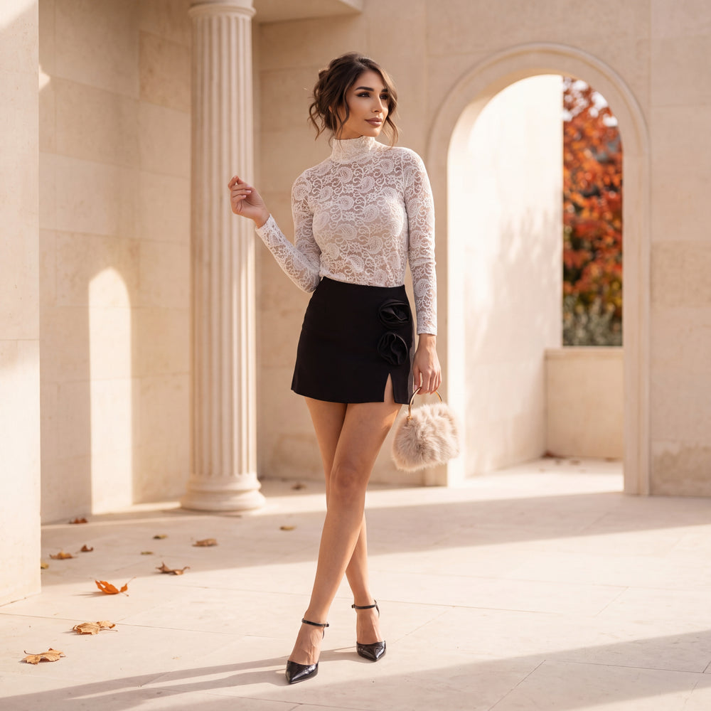 Black mini skort with sculpted fabric roses at the hip by MARIΓIOU