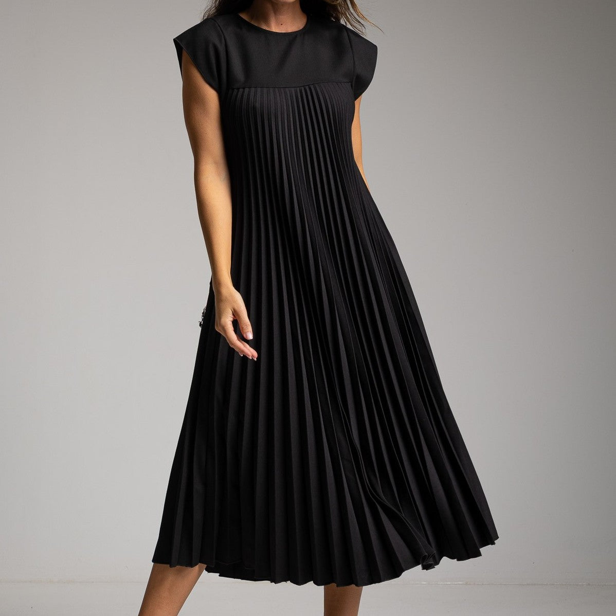 Black pleated midi dress with smooth yoke and cap sleeves - front view