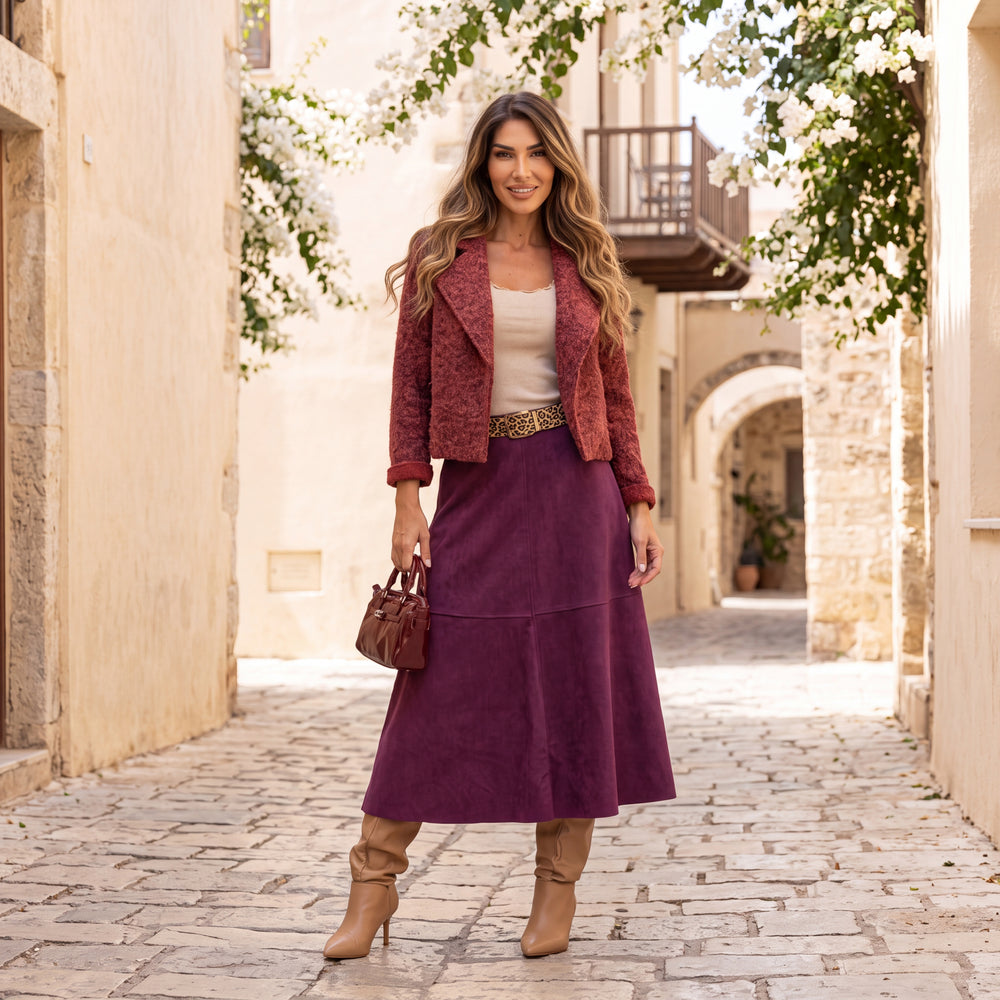 Woman wearing the Bianca Black Cherry suede midi skirt with leopard-print belt styled for autumn