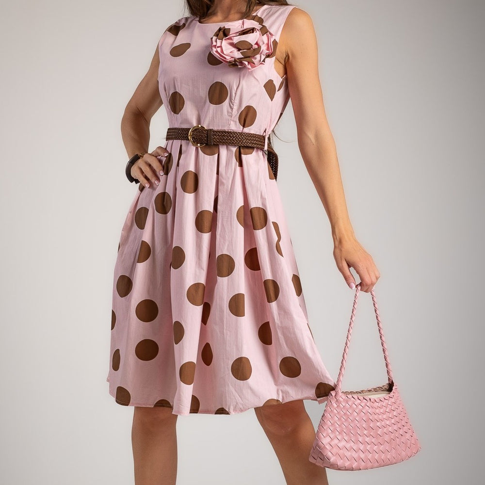 Close-up of soft blush rose cotton midi dress with oversized polka dots and floral brooch