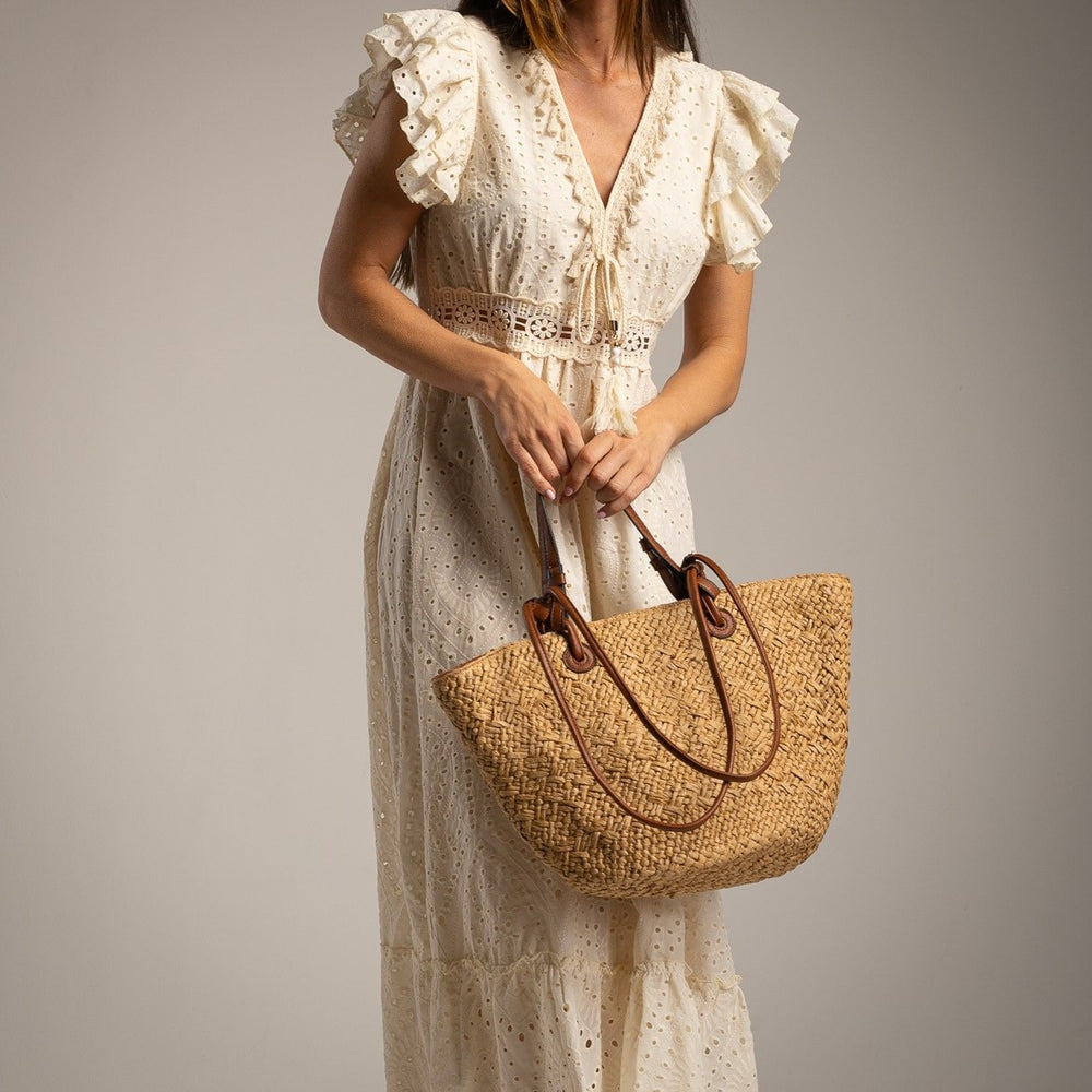 Close-up of broderie fabric in ivory white with delicate embroidery details