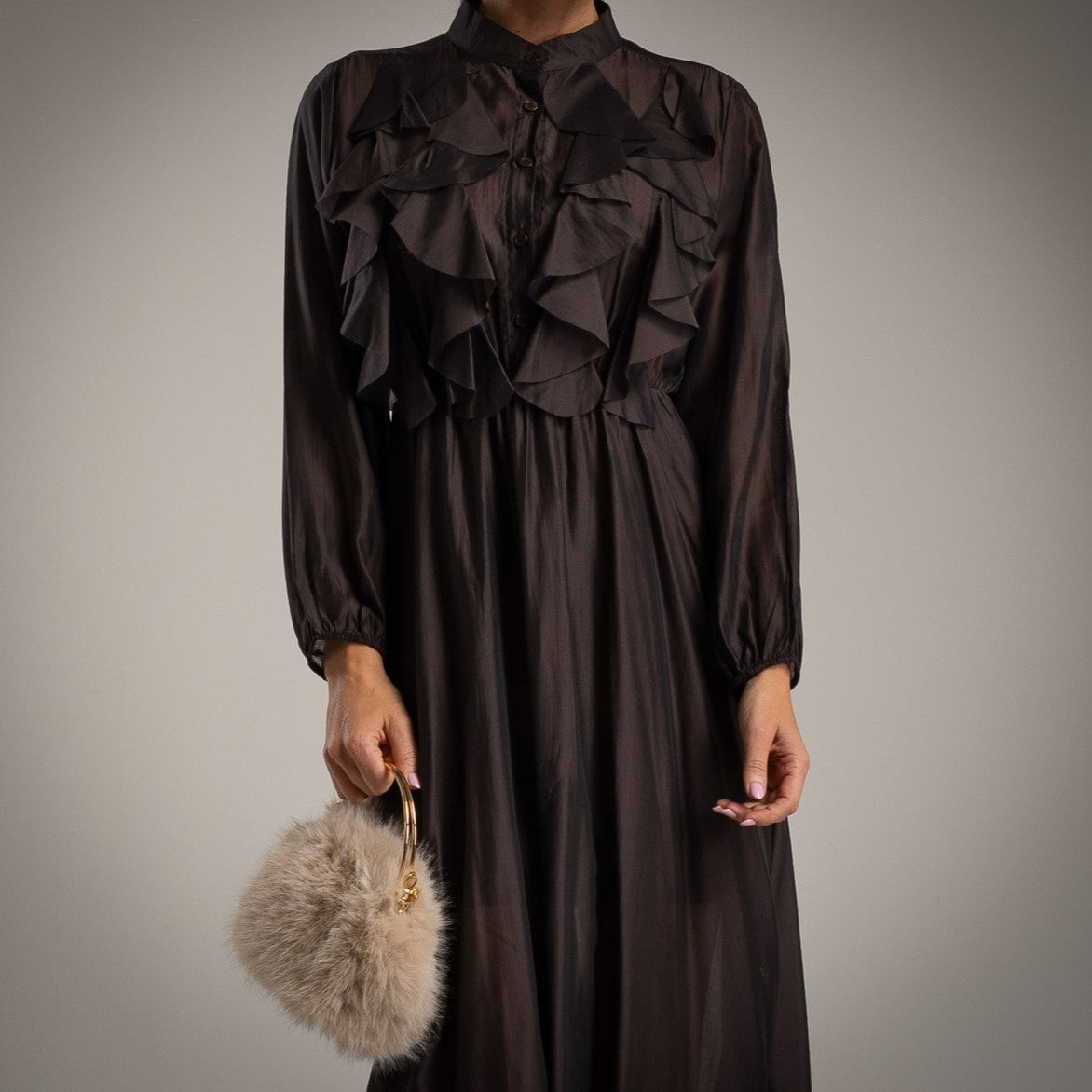 Close-up of MARIΓIOÚ brown ruffled midi dress with long sleeves and button-up front – elegant Italian-made fashion.