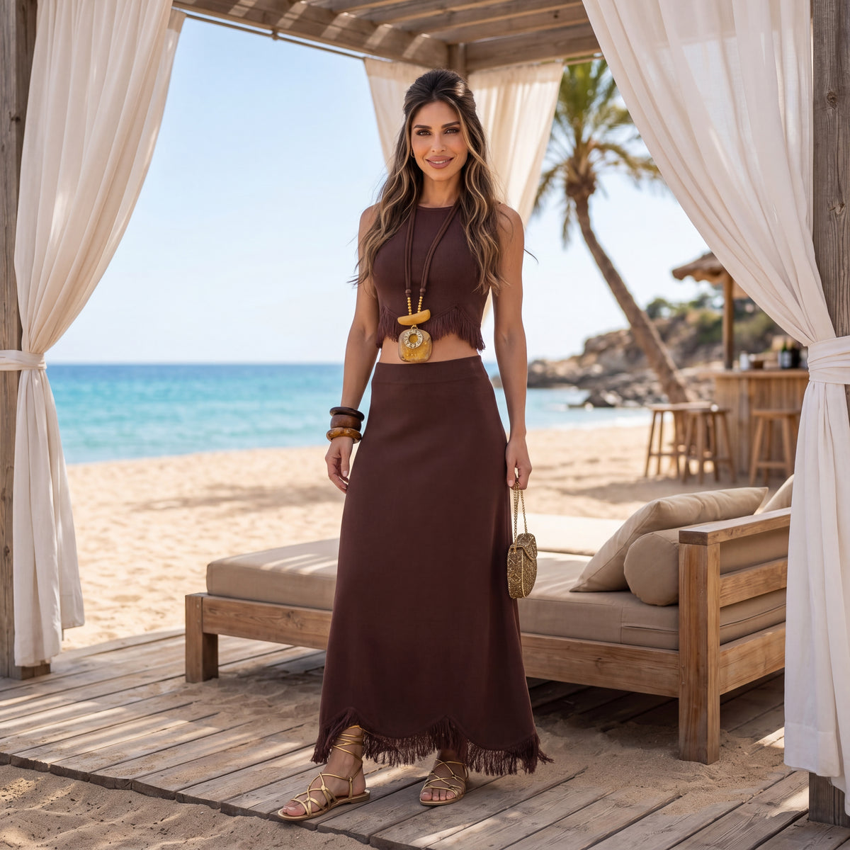 MARIΓIOÚ brown two piece resort set with fringe crop top and midi skirt styled at a luxury beach cabana