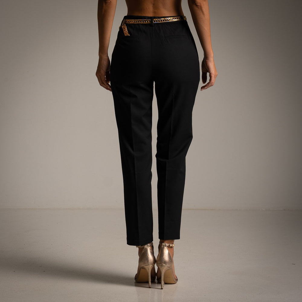 Black tailored cropped trousers with pressed crease and slim tapered leg - back view