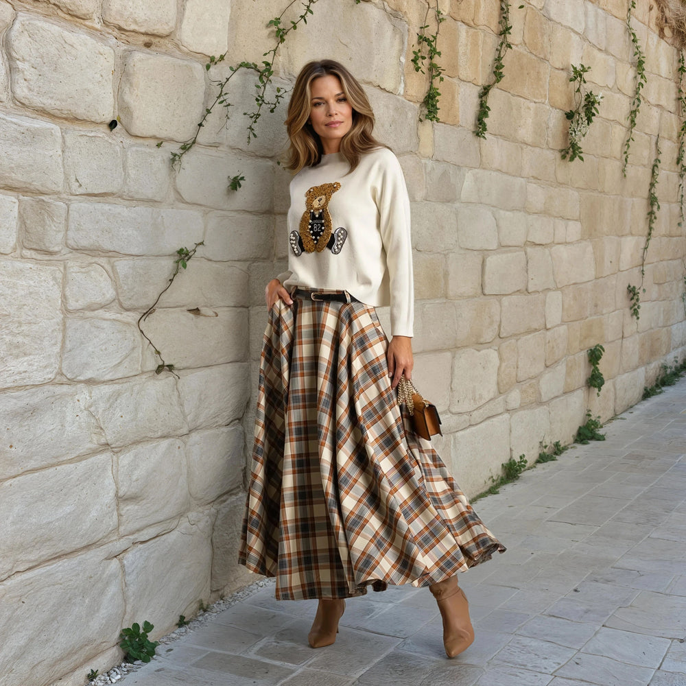 Street style outfit with MARIΓIOÚ checked midi skirt and beige sweater