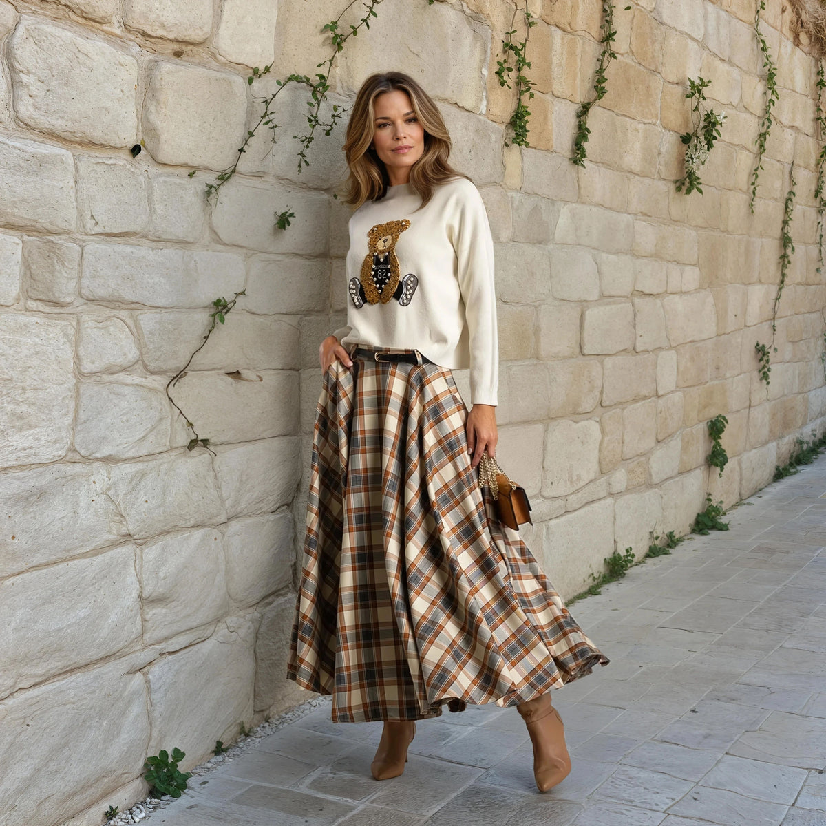 Street style outfit with MARIΓIOÚ checked midi skirt and beige sweater