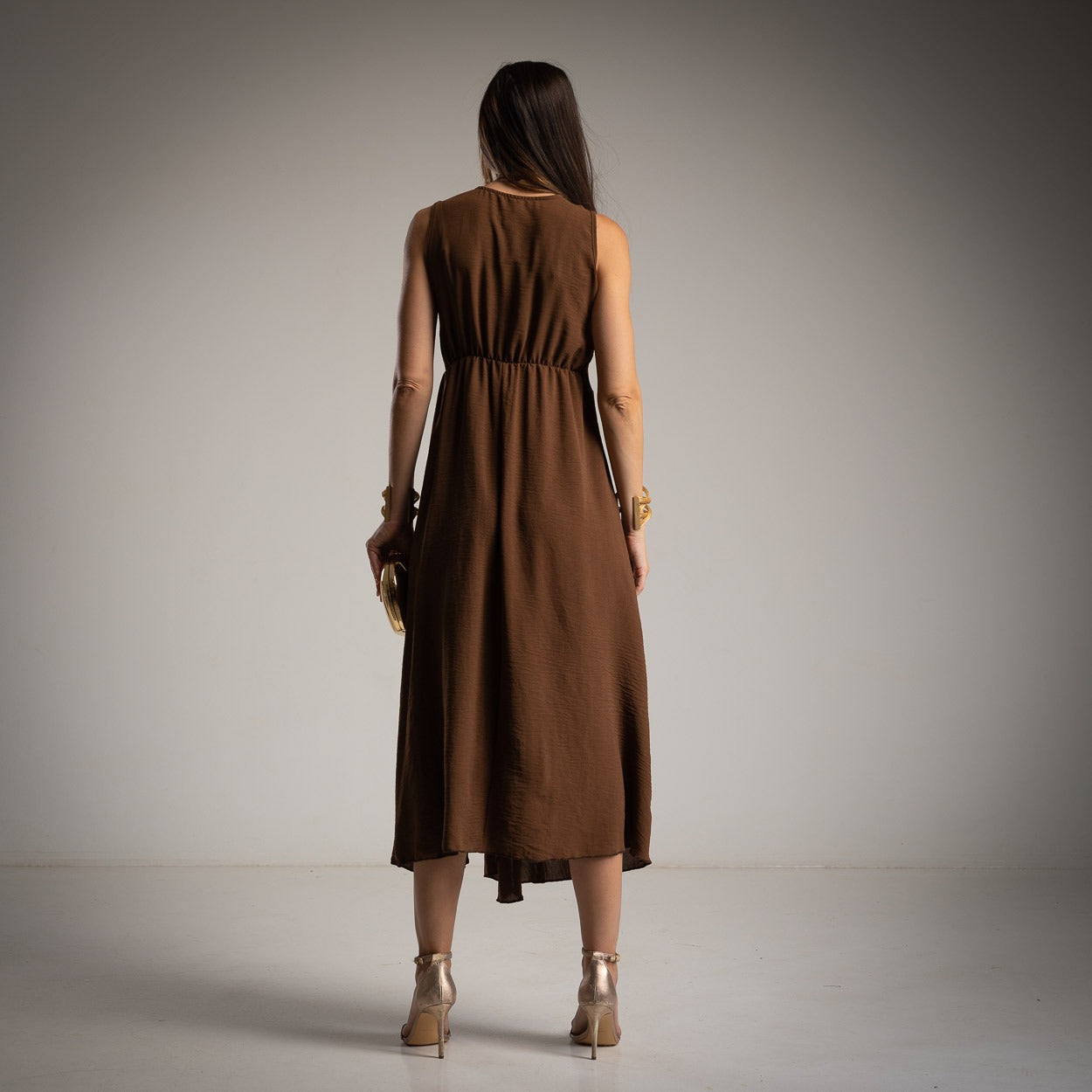 Chocolate Brown sleeveless asymmetrical midi dress back view with lightweight flowing fabric