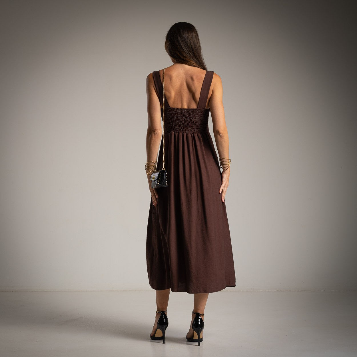 Chocolate midi dress back view with smocked bodice and feminine flowing silhouette