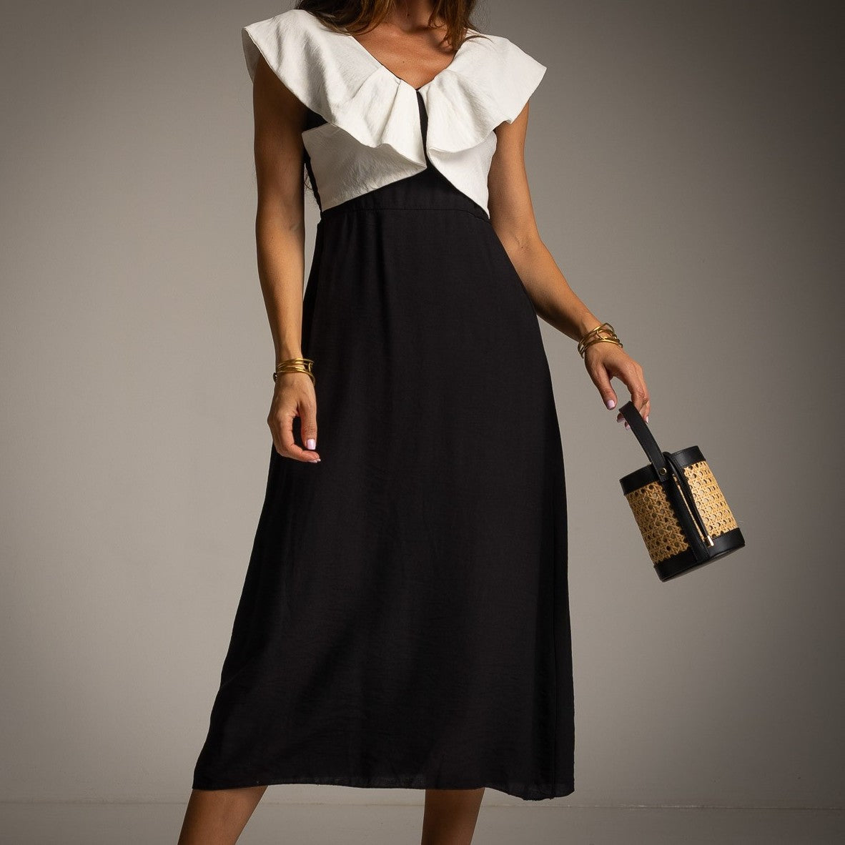 Close-up of Classic Black midi resort dress with oversized ruffle neckline