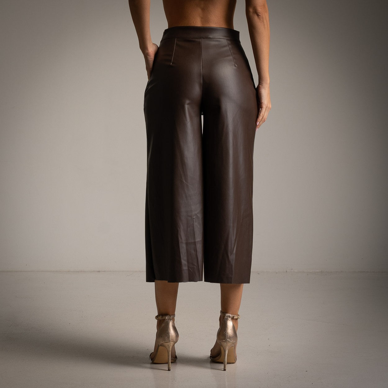 Back view of Cocoa Brown faux leather wide-leg culottes with a high-waisted fit.