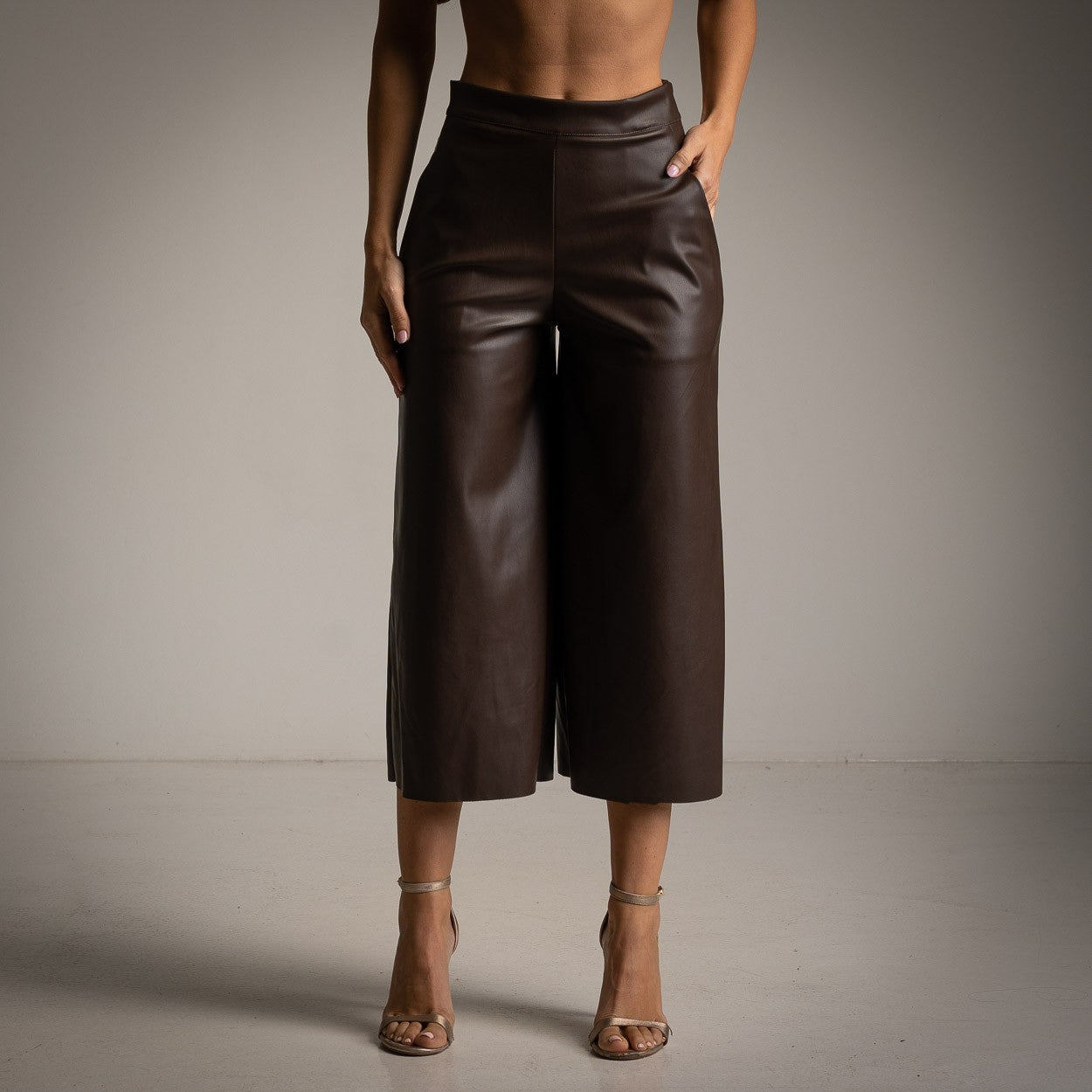 Front view of elegant Cocoa Brown faux leather culottes with a cropped wide-leg silhouette.