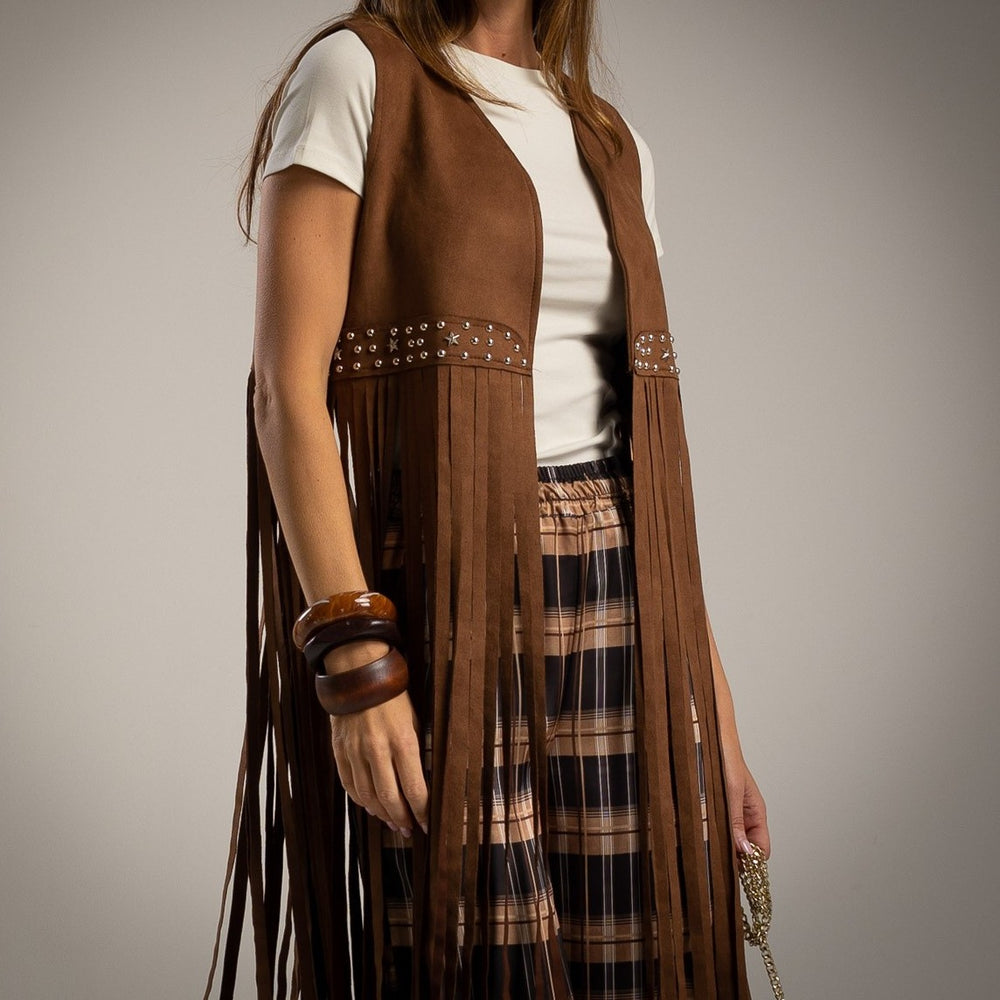 Close-up of the Dakota suede fringe vest featuring decorative studs and long fringe.