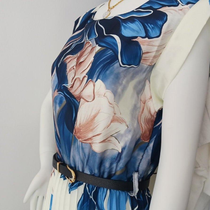 Detail view of pleated floral midi dress with elegant belt and deep ocean blue floral print
