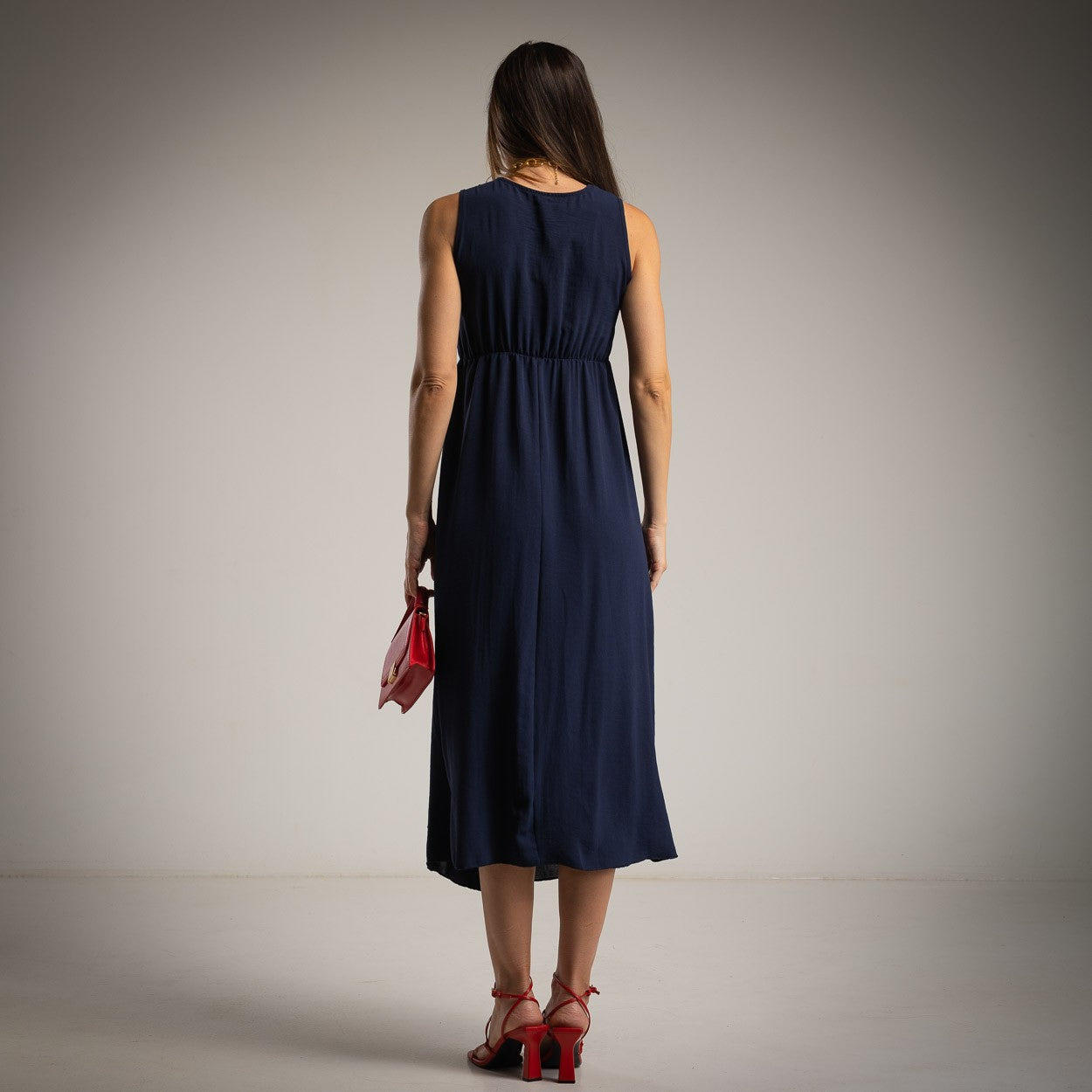 Deep Ocean Blue sleeveless asymmetrical midi dress back view with flowing skirt and elastic waist detail