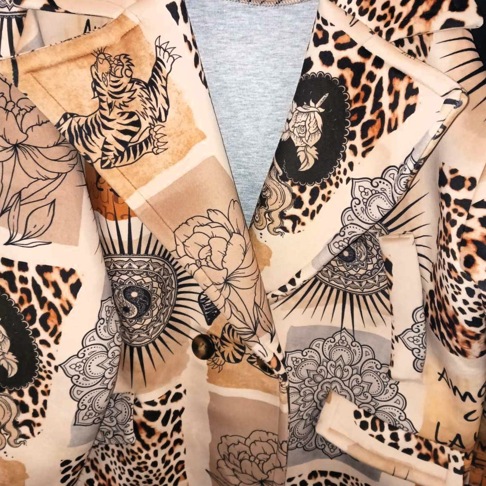 Beige animal collage print with leopard spots, mandalas and hand-drawn florals on soft neoprene plush - detail view
