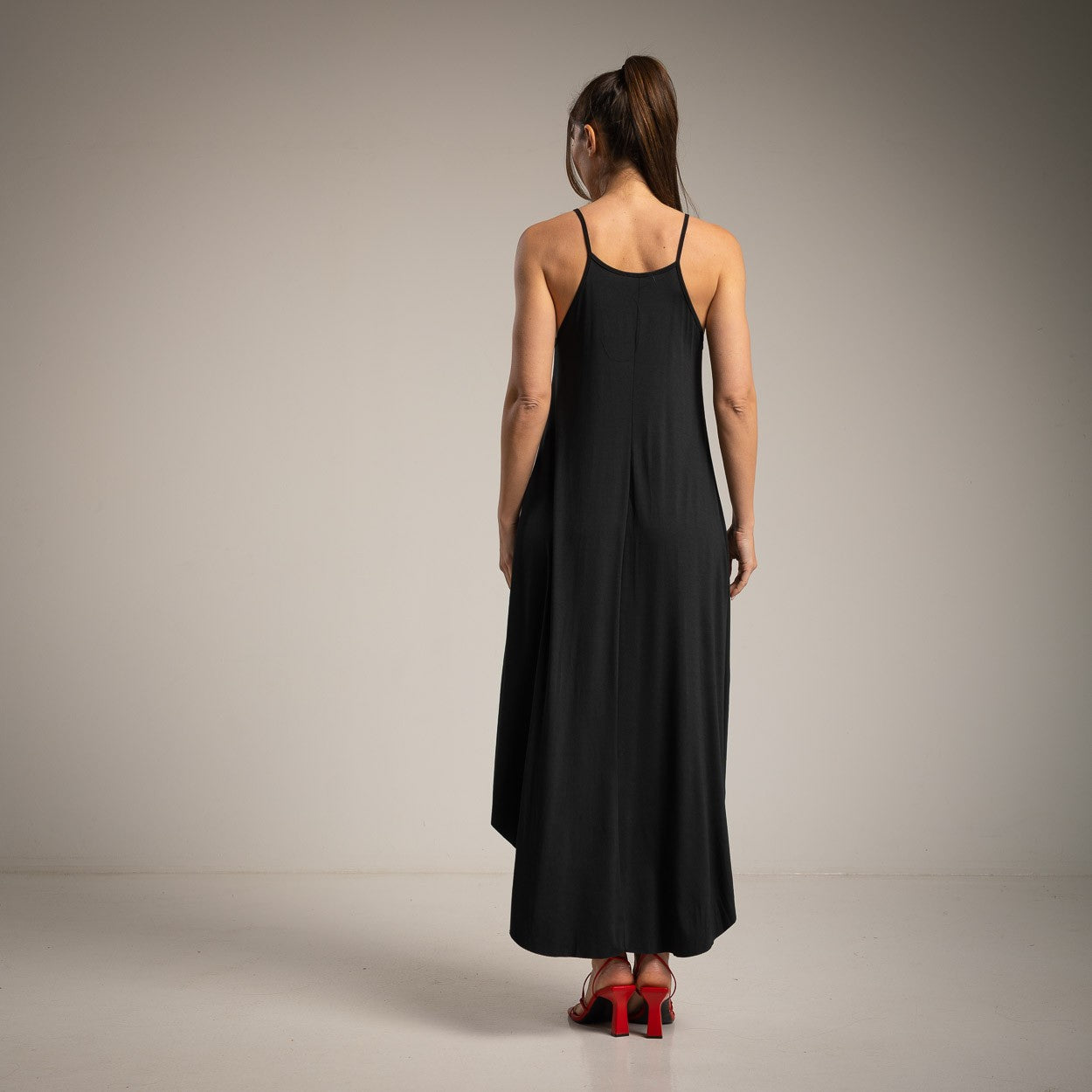 Elegant black midi dress back view with thin straps and relaxed fit