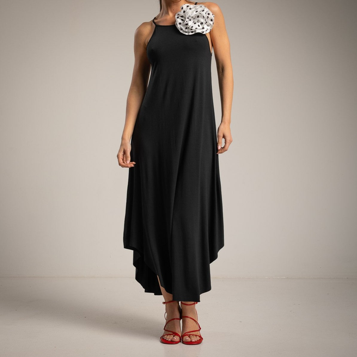 Elegant black midi dress front view with flowing silhouette and minimalist design