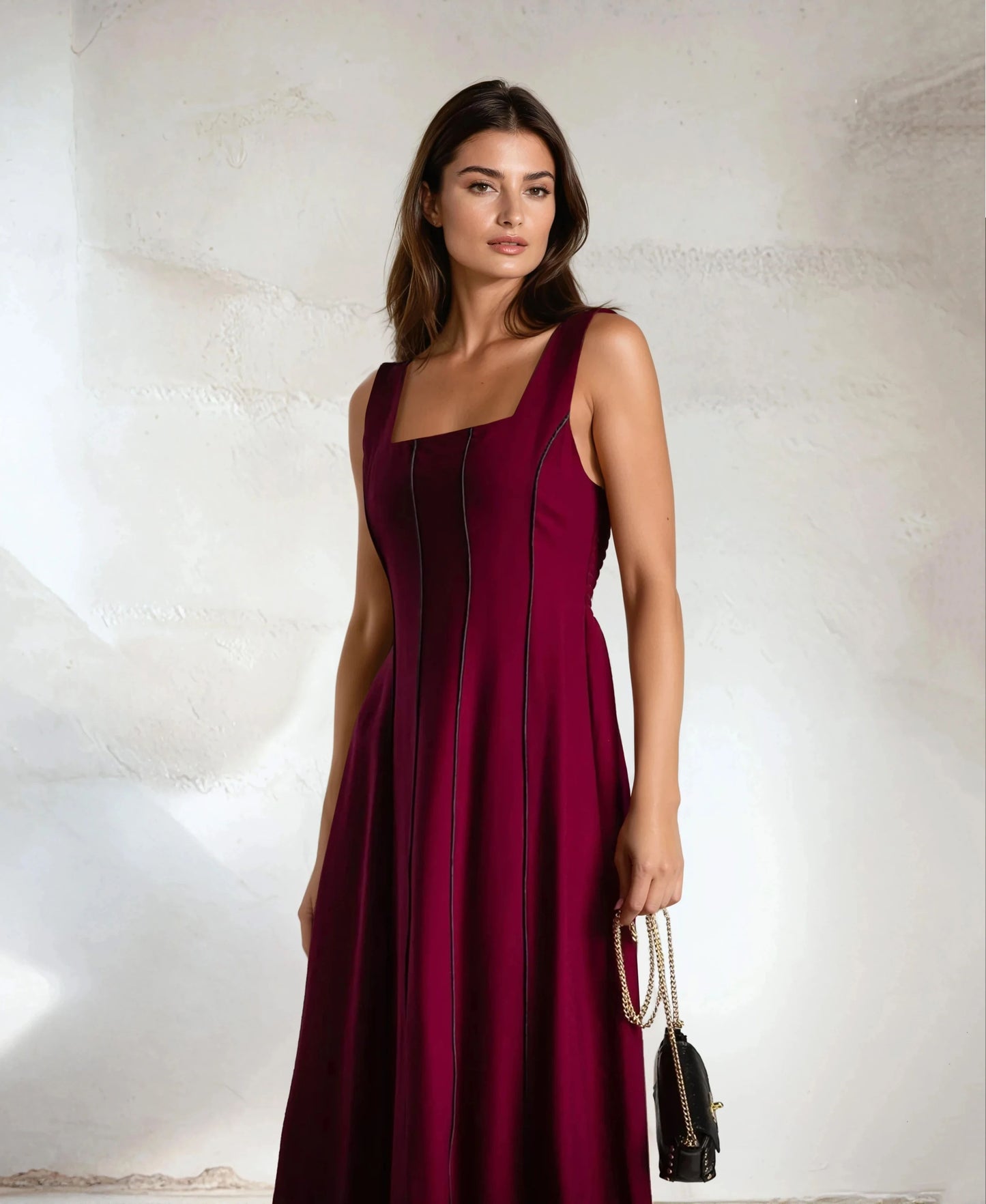 Close-up detail of MARIΓIOÚ elegant burgundy midi dress with black vertical stripes