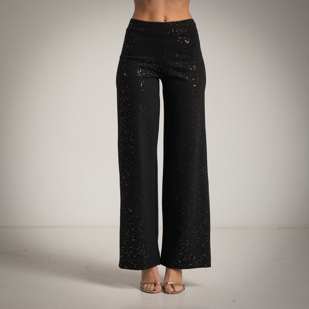 Black high-rise flared pants with scattered golden glitter foil - front view