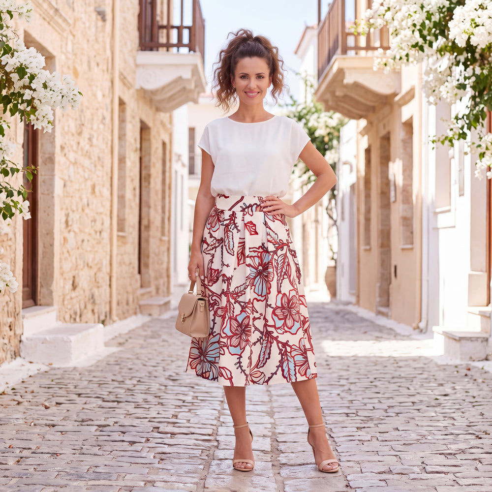 Woman wearing MARIΓIOÚ floral print midi skirt in a Mediterranean summer setting