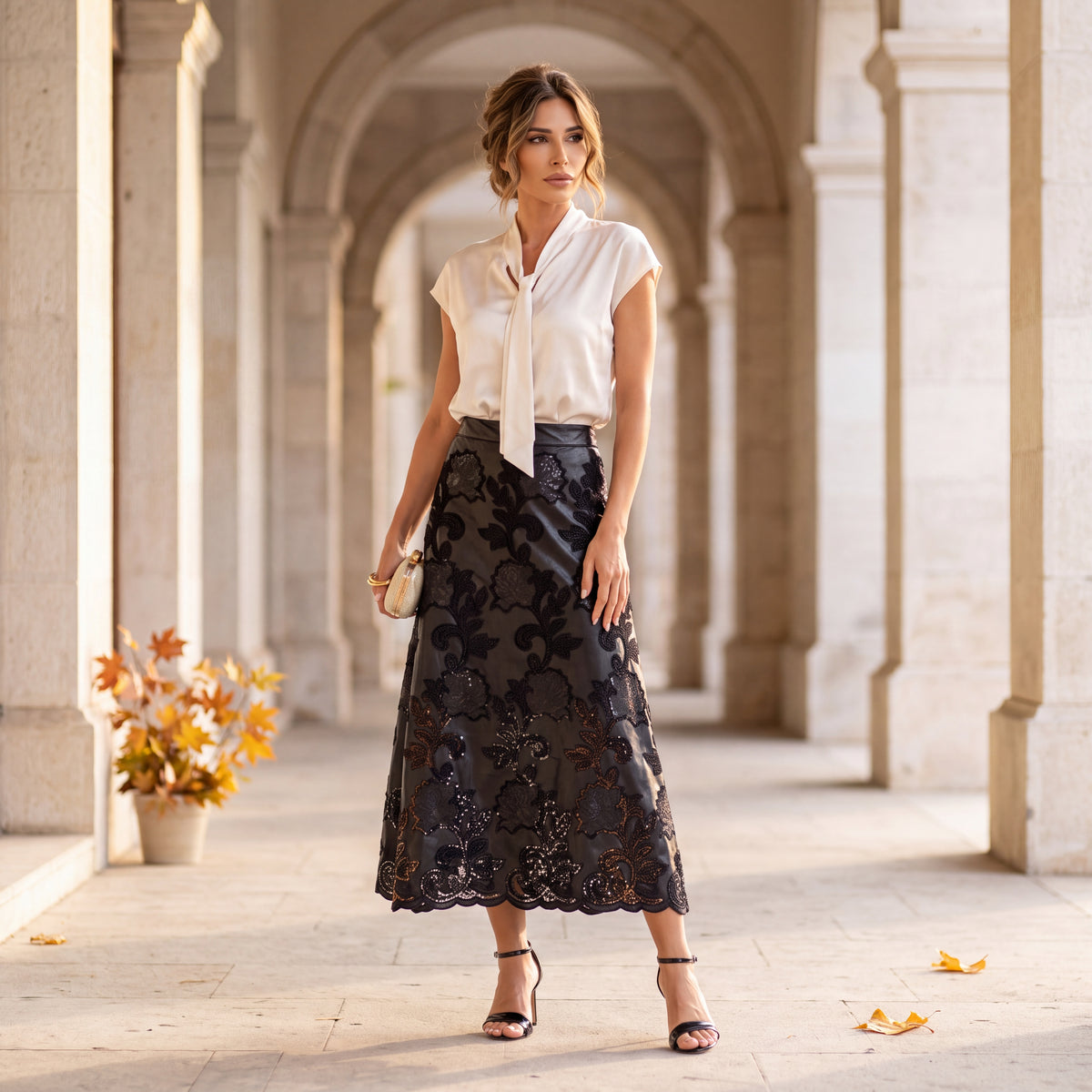 Black laser-cut floral faux leather midi skirt with scalloped hem by MARIΓIOU