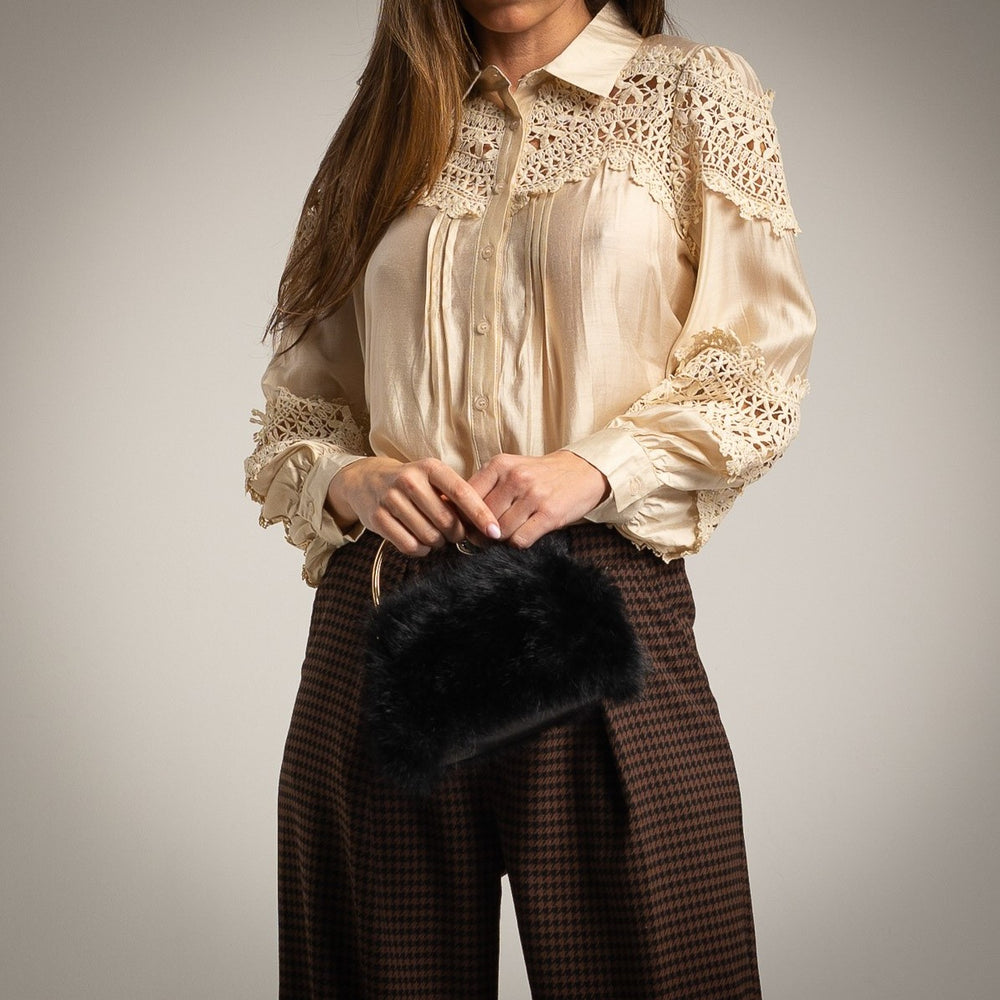 Detail view of guipure lace blouse shoulder and sleeve