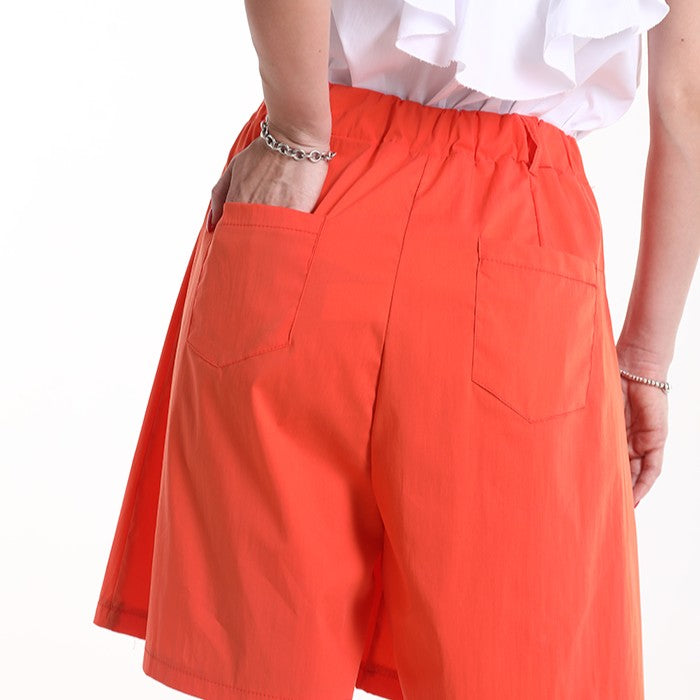 Back view of orange sunset high-waist Bermuda shorts with back pockets by MARIΓIOÚ