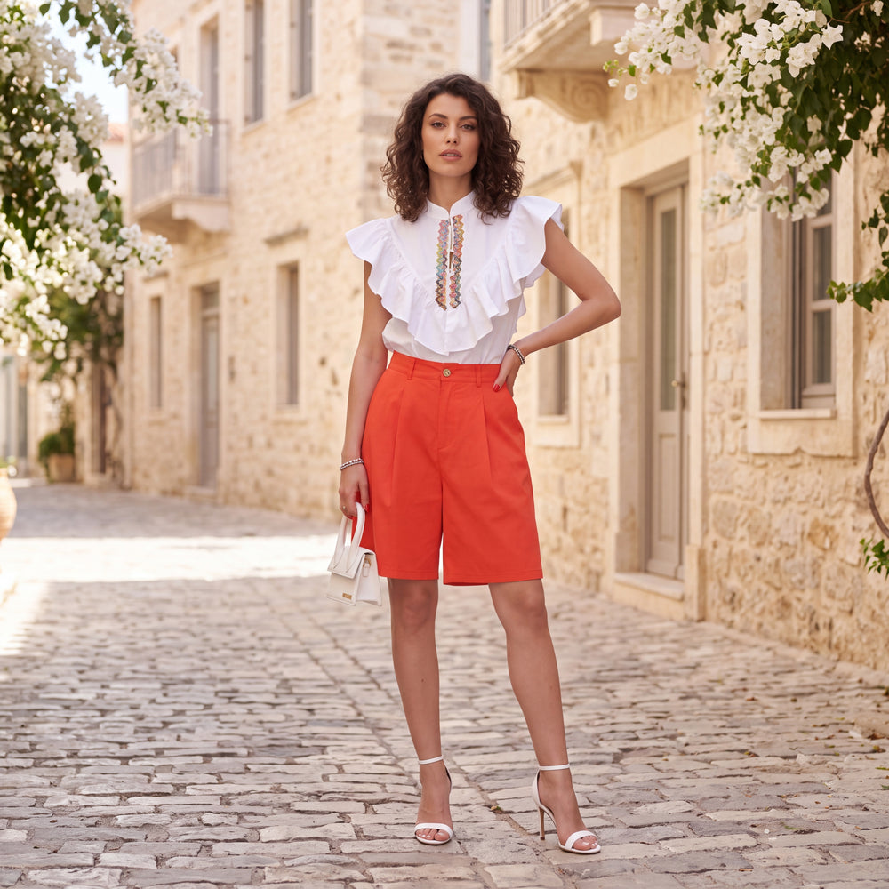 Orange sunset high-waist Bermuda shorts styled with white blouse by MARIΓIOÚ
