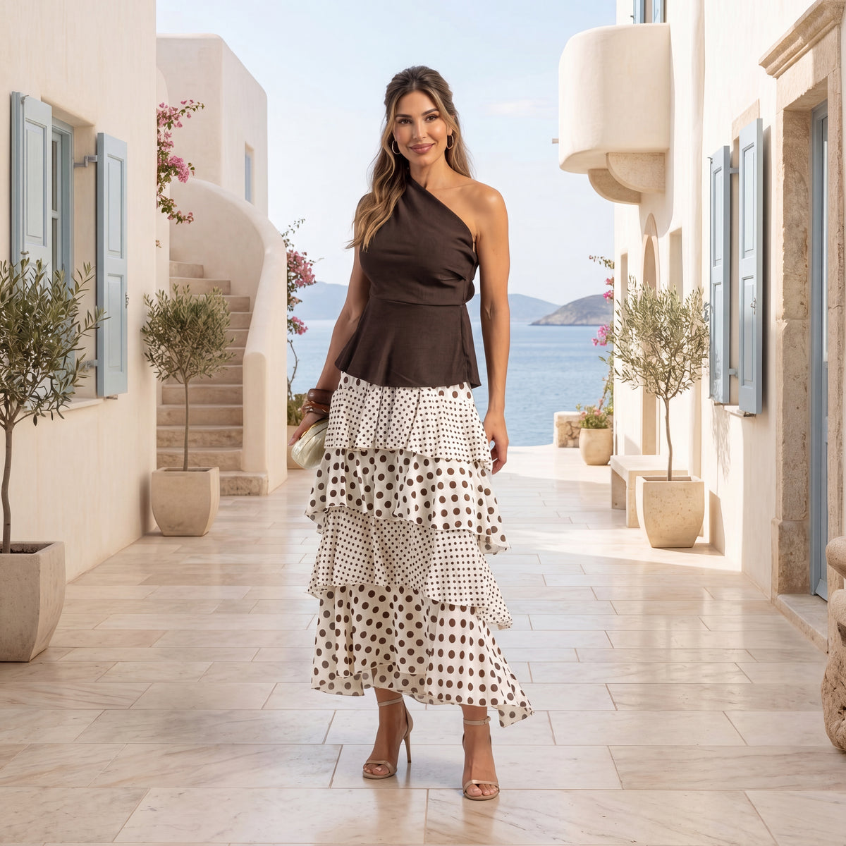 Woman wearing ivory white and chocolate polka dots layered maxi skirt with elegant Mediterranean styling