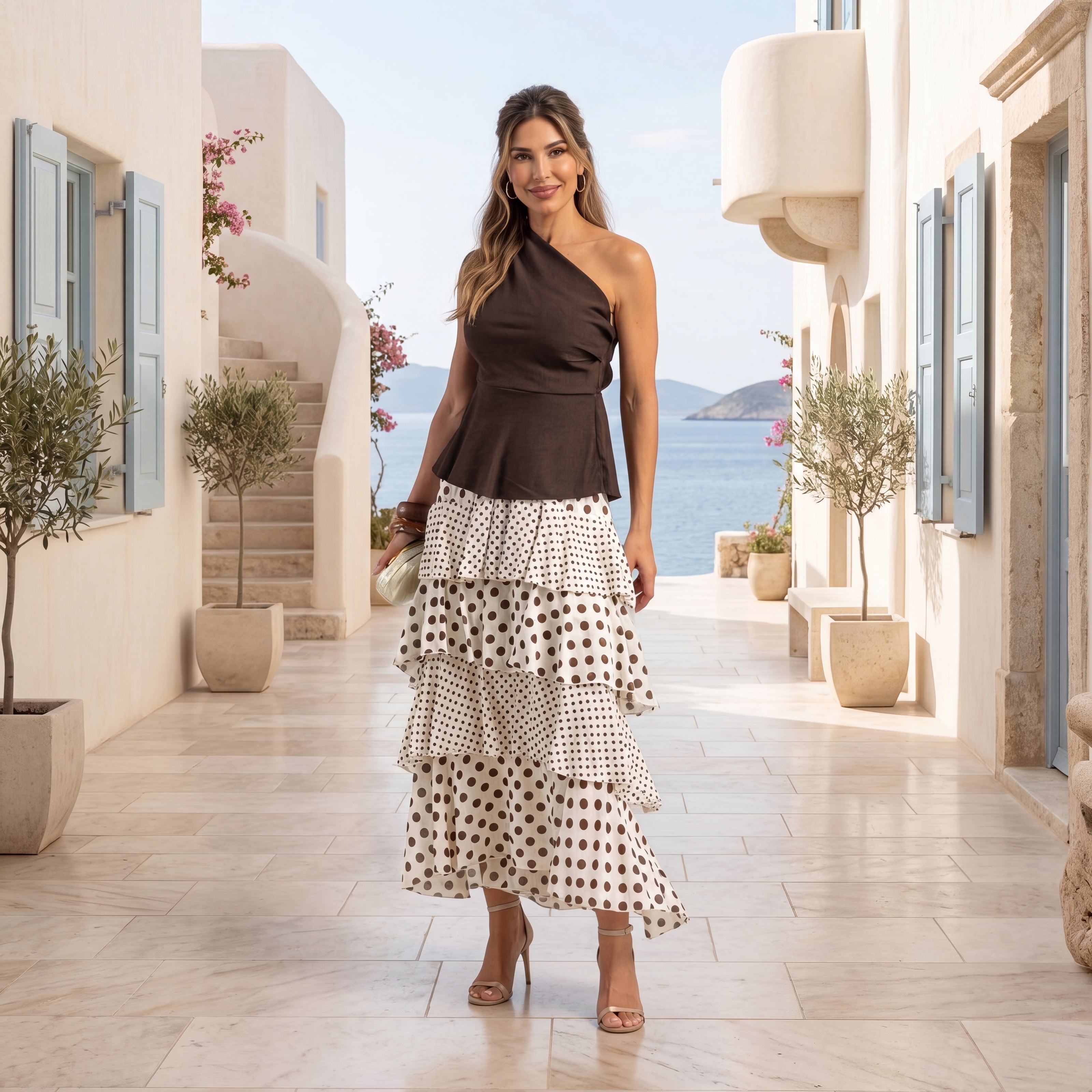 Woman wearing ivory white and chocolate polka dots layered maxi skirt with elegant Mediterranean styling